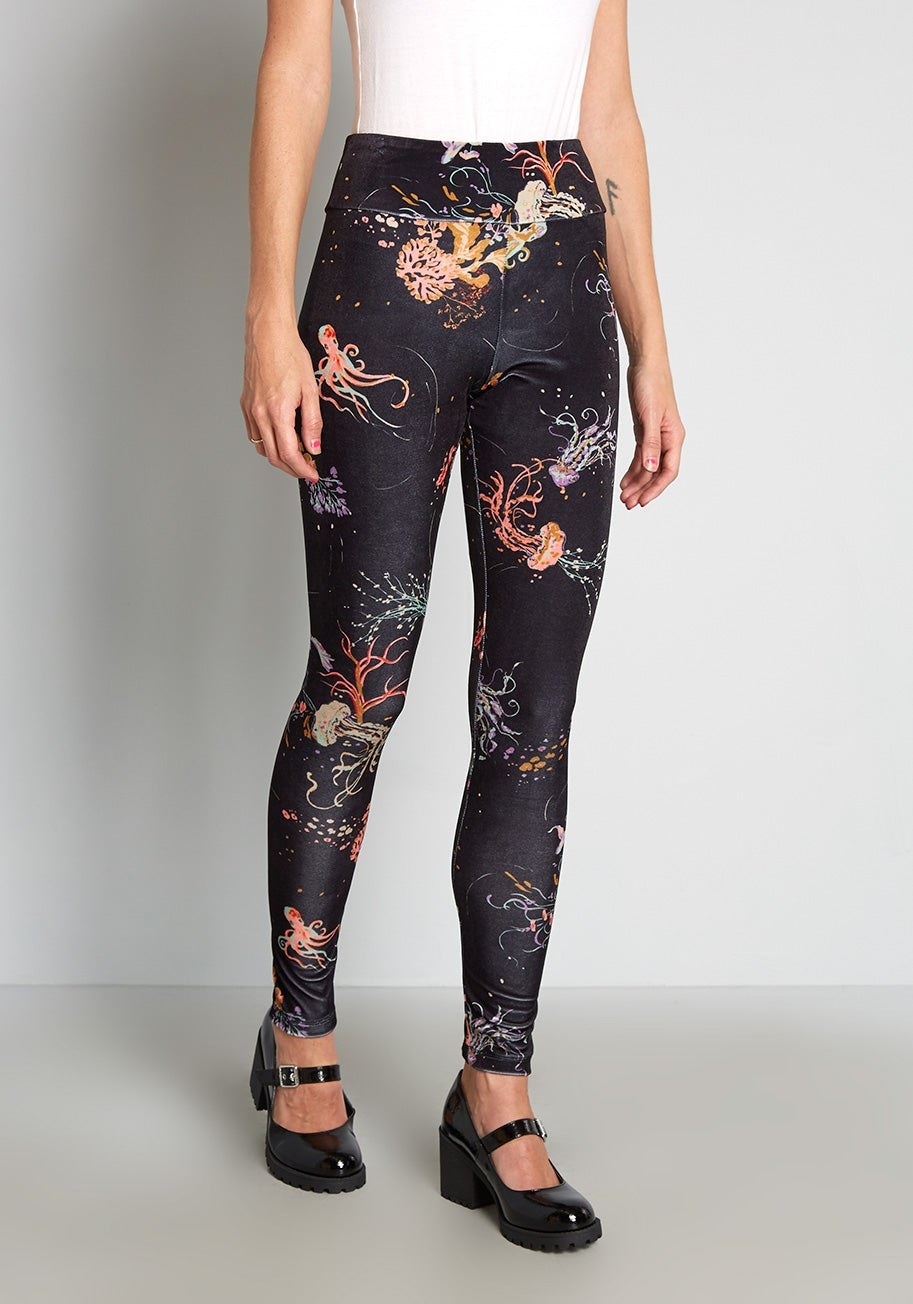 model wearing black leggings printed with octupuses and jellyfish