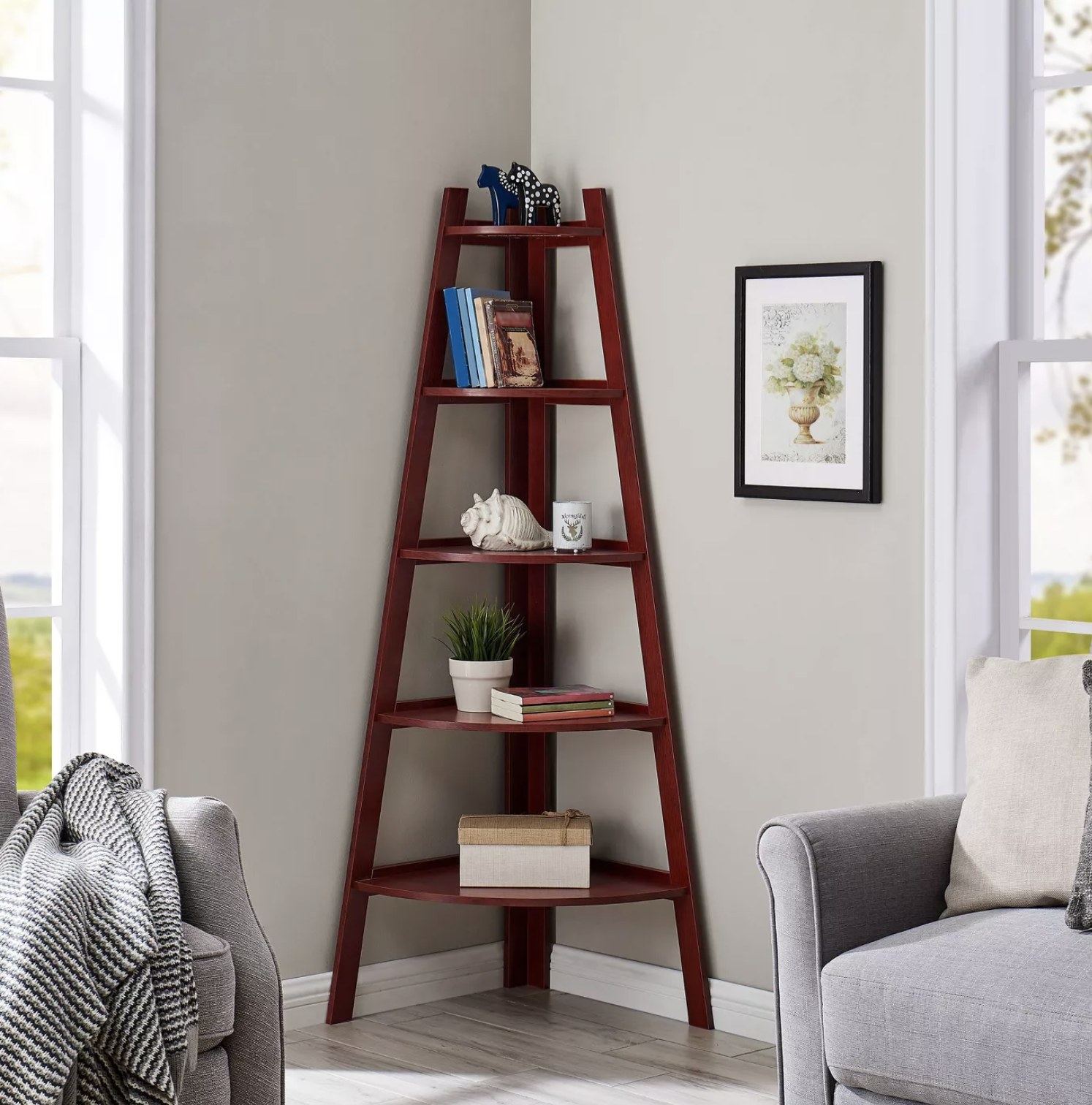 the red ladder bookshelf with decor and books on it