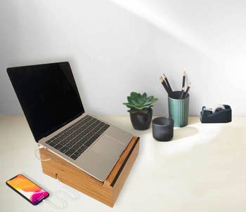 the bamboo laptop stand with a MacBook on top of it