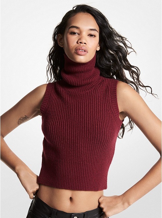 Model wearing a sleeveless tank top sweater