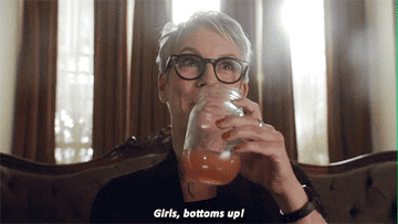 woman drinking, caption says girls, bottoms up!