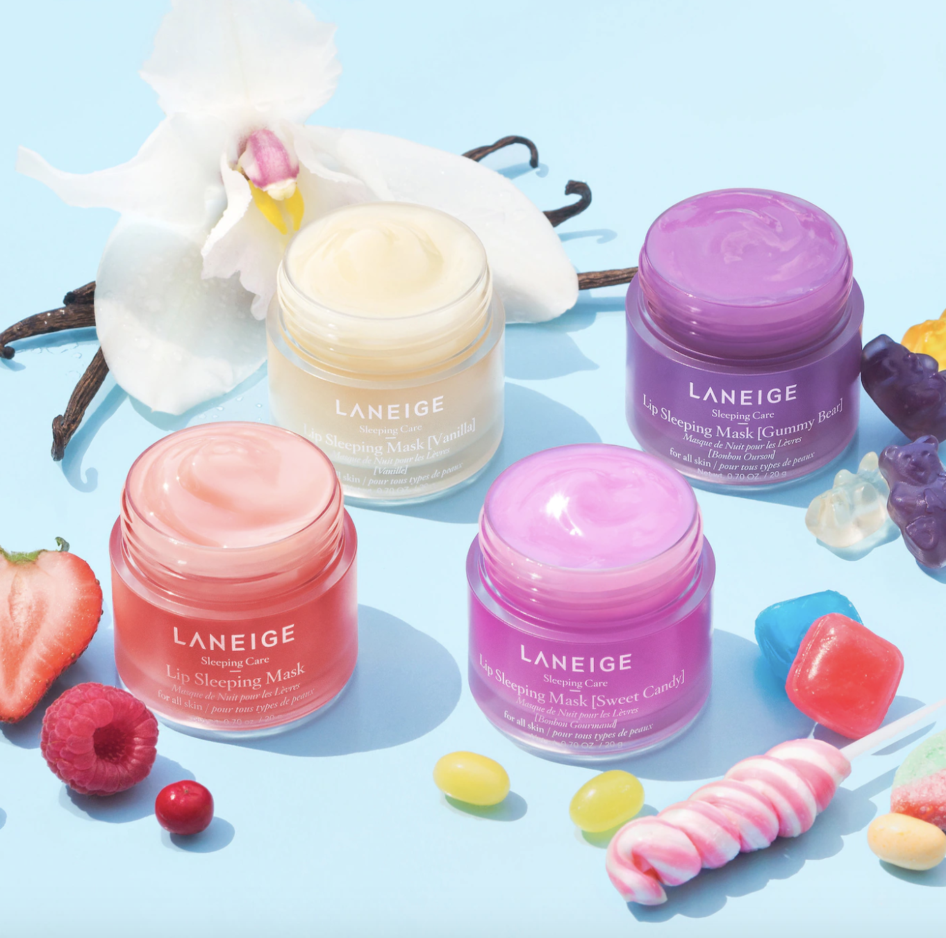 the four flavors of laneige lip mask, surrounded by fruit and candy