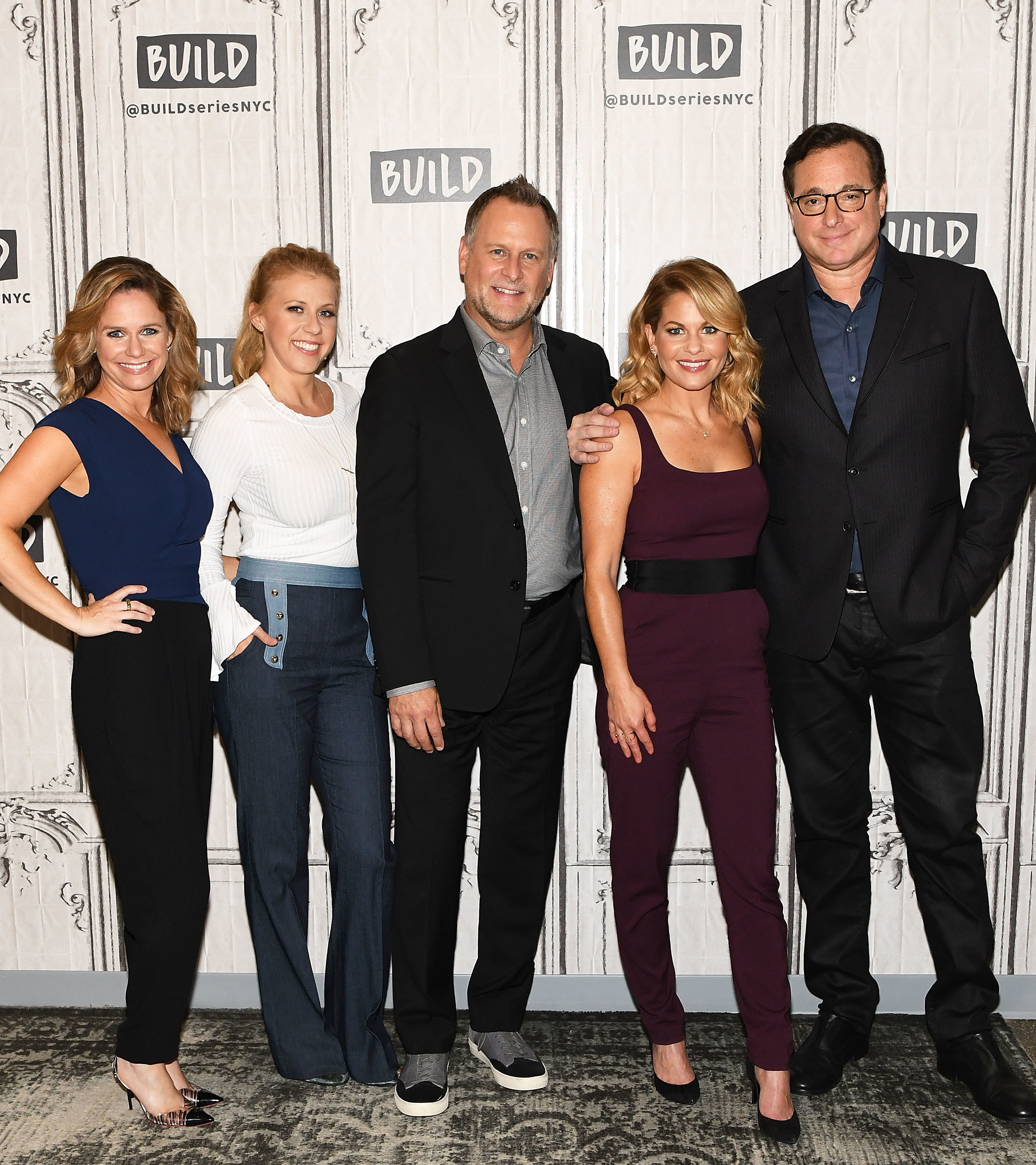 The cast of Fuller House at a step-and-repeat