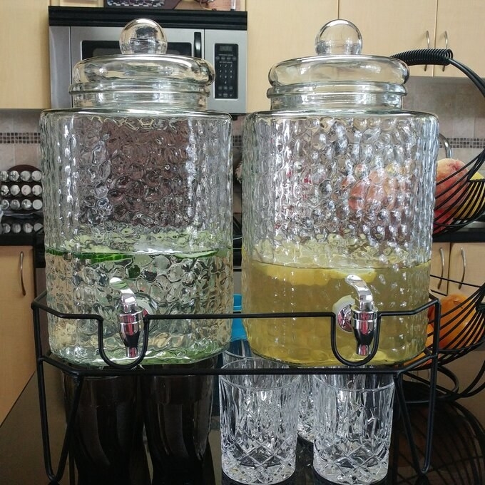 reviewer&#x27;s image of the beverage dispensers in use on her counter