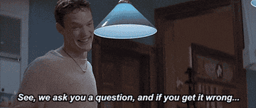 GIF of Stu from Scream saying &quot;See, we ask you a question, and if you get it wrong...BOOGAH!&quot;