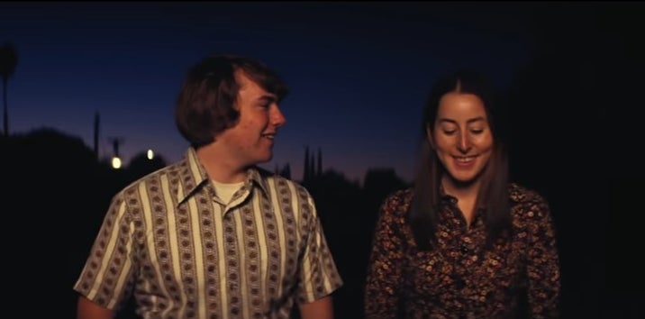 Gary and Alana walking together at night in "Licorice Pizza"