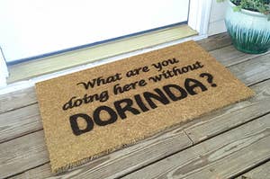 a door mat that says "what are you doing here without dorinda?"
