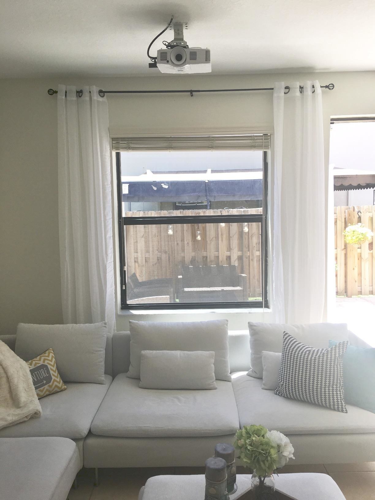 reviewer&#x27;s living room with white sheer curtains hanging on windows