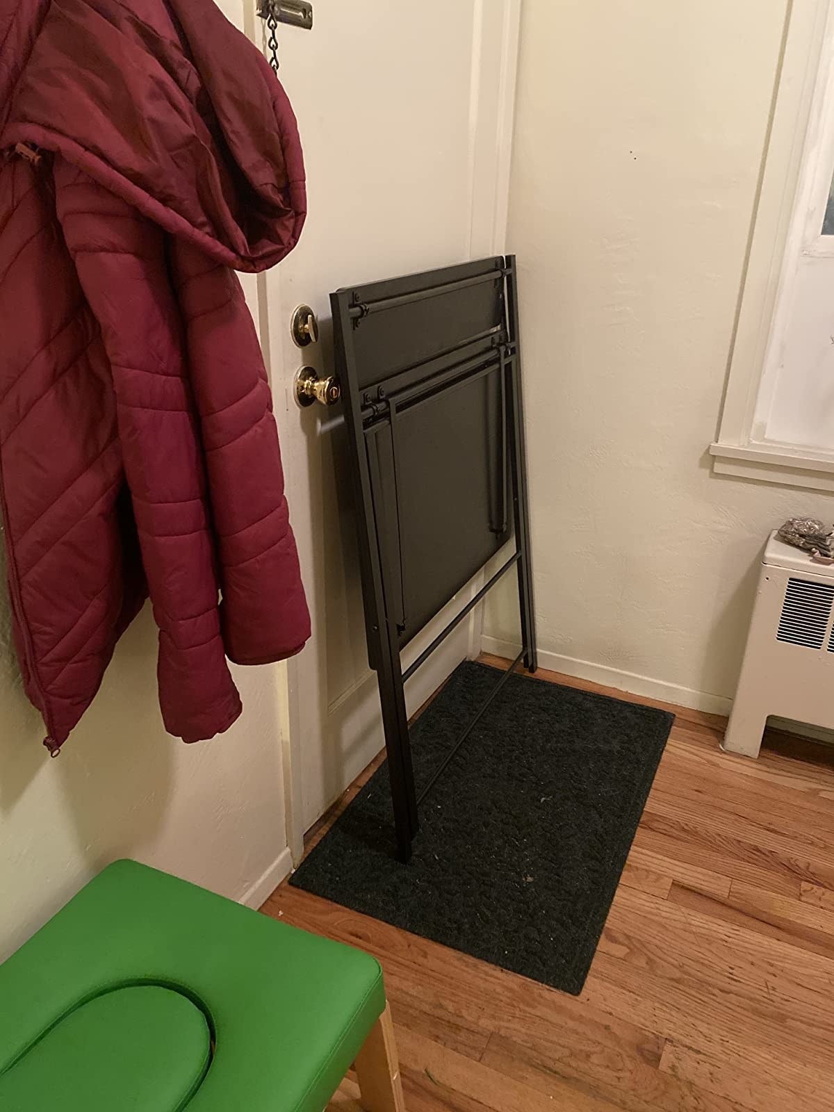 Another reviewer's folded up   table  successful  achromatic  propped against a wall