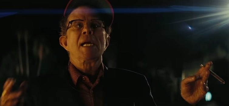 Rex Blau standing outside with a cigarette in "Licorice Pizza"