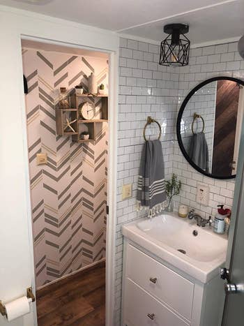 reviewer's RV camper bathroom with tile behind sink vanity
