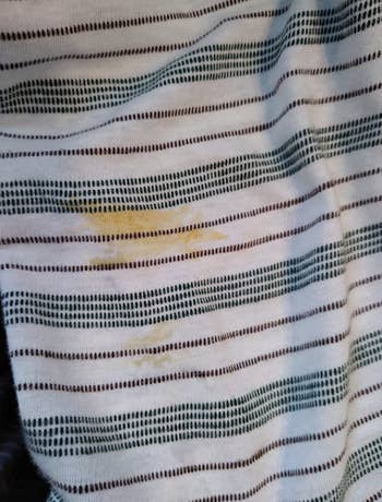 white striped shirt with visible stain yellow orange on it