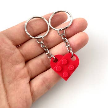 the keychain heart in red in someone's hand