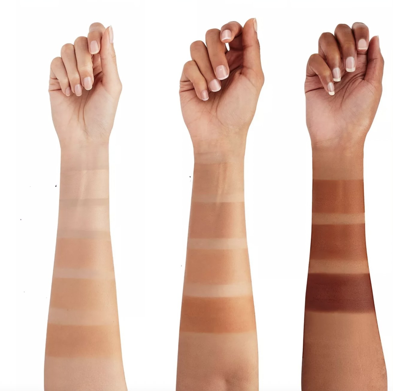 A set of tinted moisturizer swatches on three different complexions