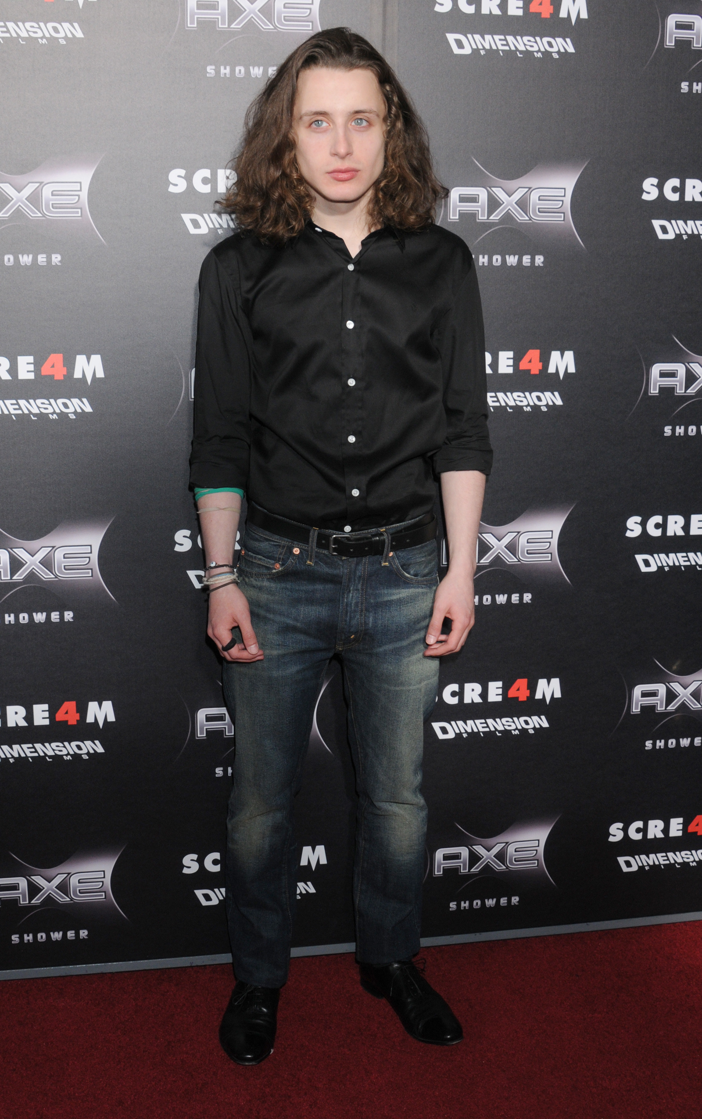 Rory Culkin in jeans and a black button-down shirt