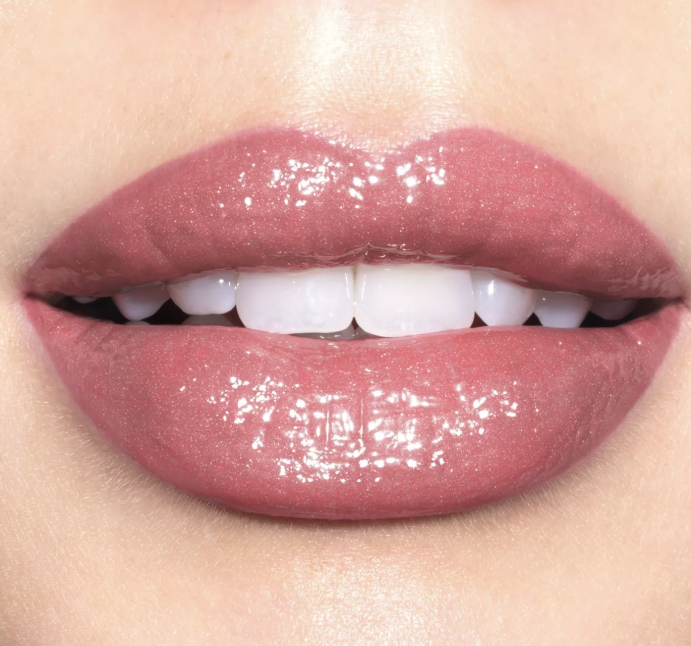A person wearing pink shiny lipstick