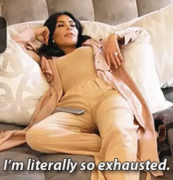Kim Kardashian lying on the cushion half-asleep seeing, &quot;I&#x27;m literally so exhausted&quot;