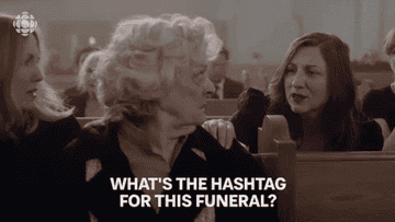 A woman in a funeral asking, &quot;What&#x27;s the hashtag for this funeral?&quot;