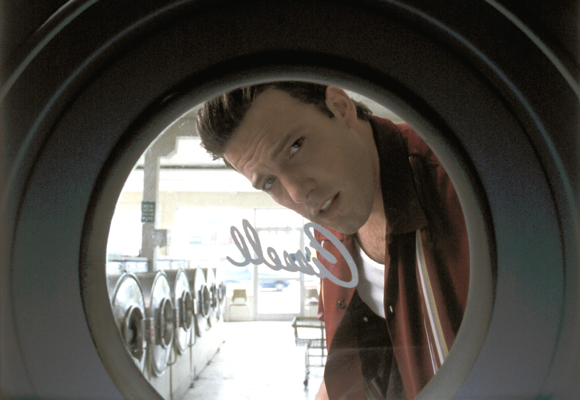 Affleck looks into a washing machine
