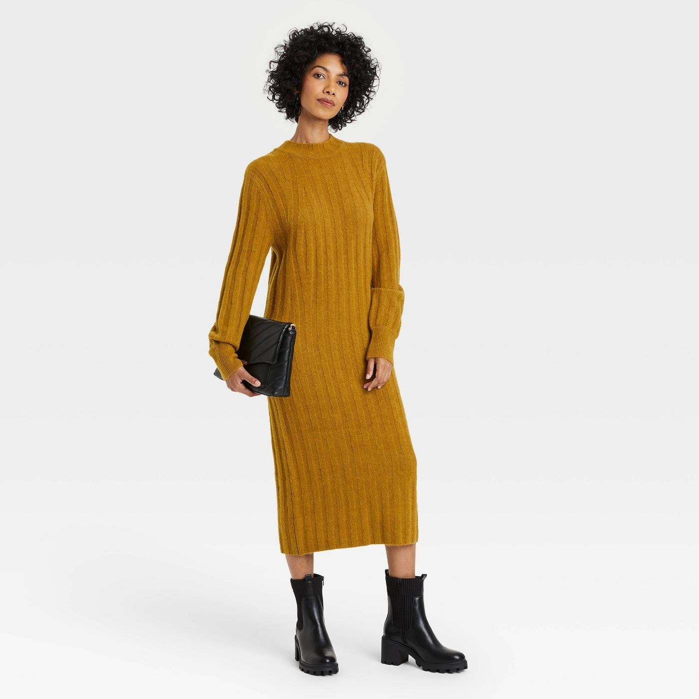 model wearing the sweater dress in mustard