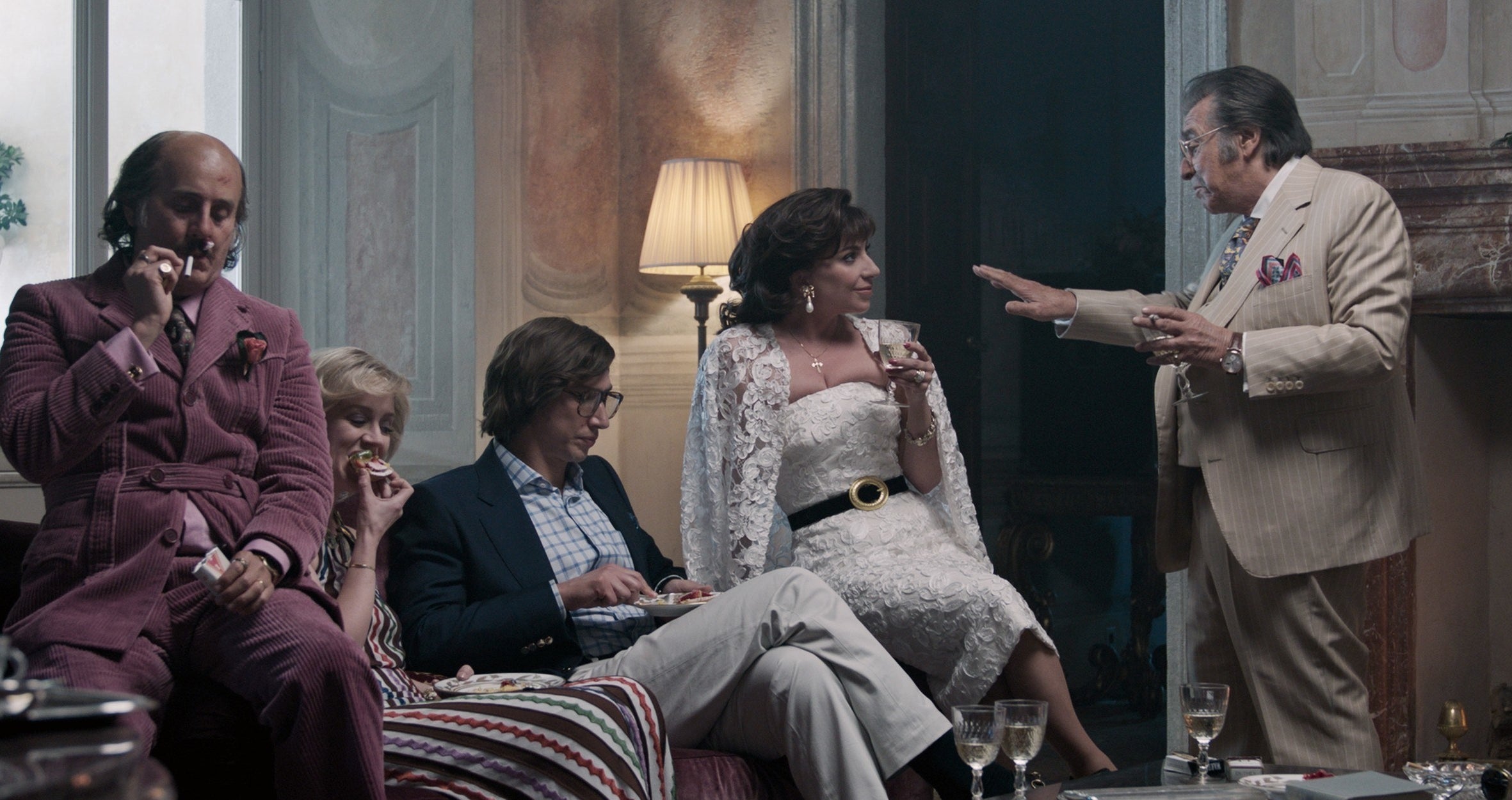 The Gucci family sits on a couch together in the film