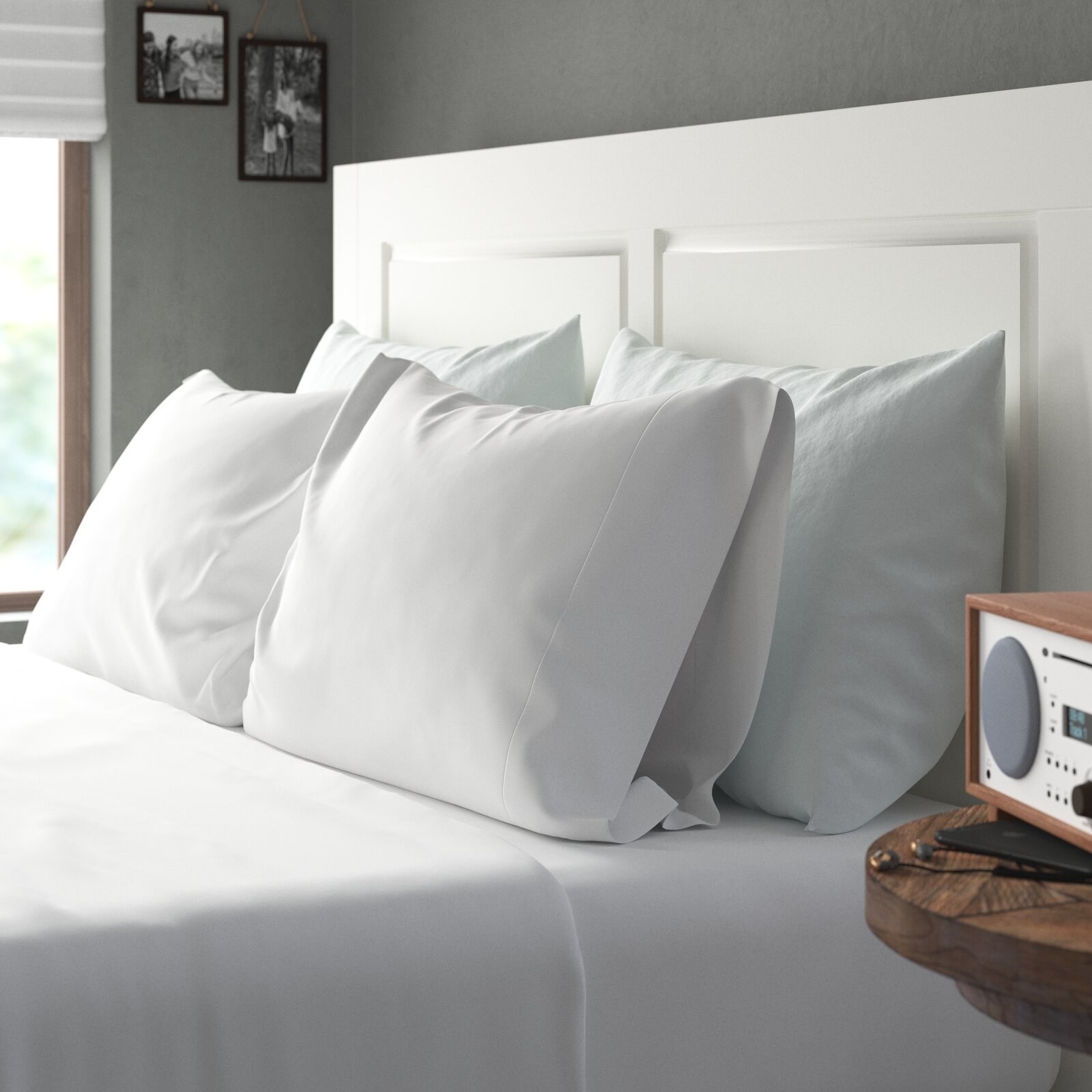 sheet set in white on a bed with four pillows and white headboard