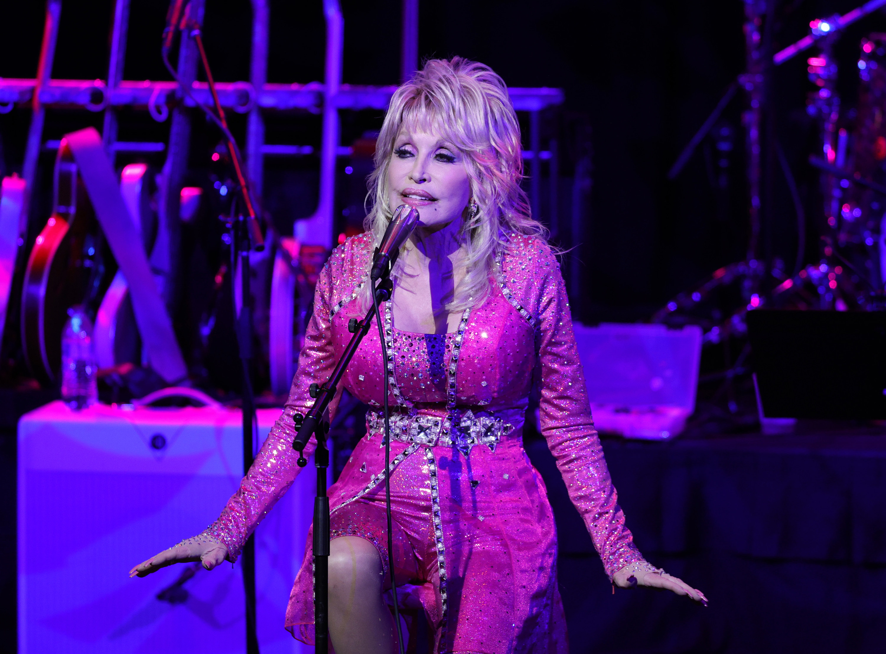 Dolly performing in a pink outfit at a benefit