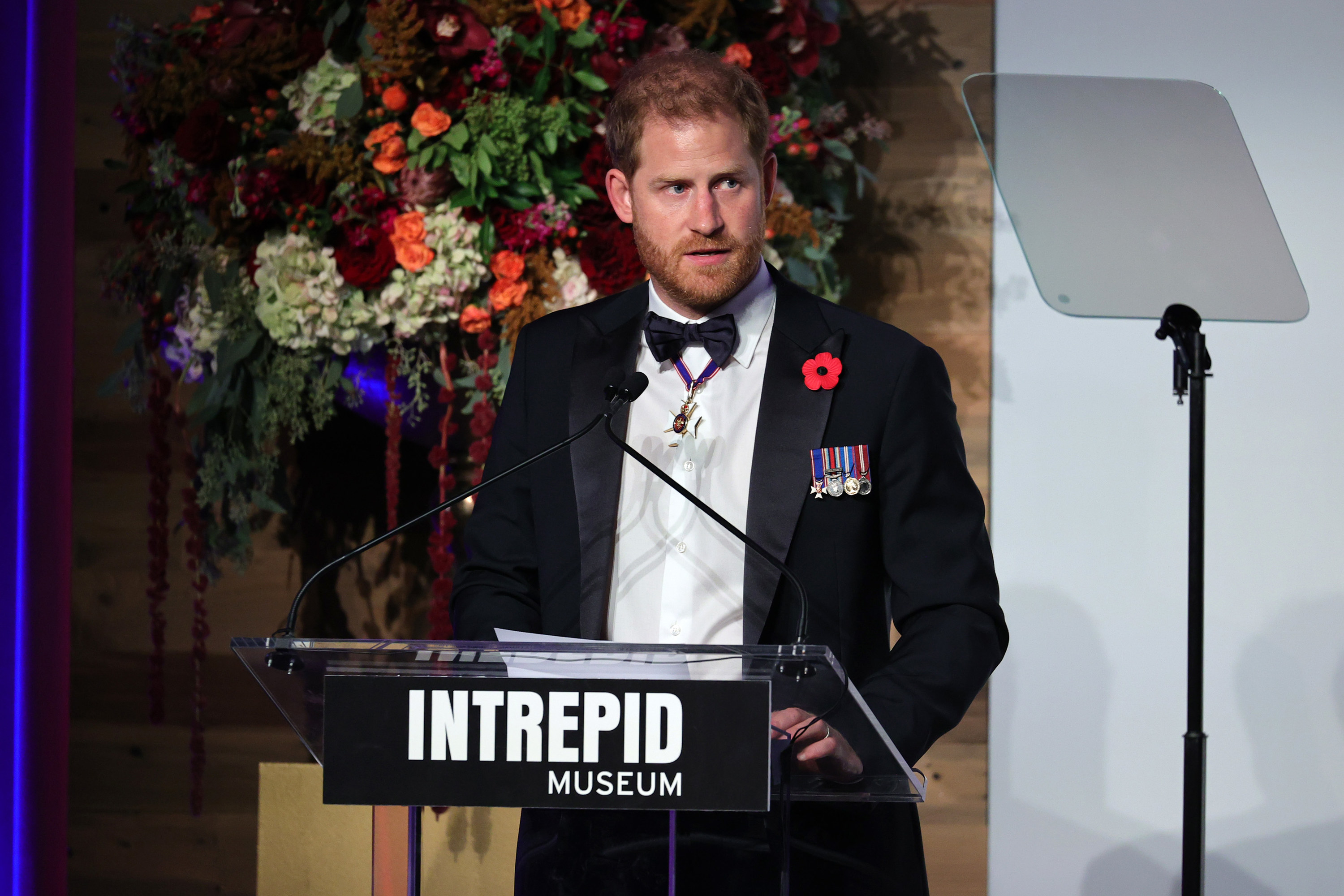 Prince Harry is speaking onstage at the Intrepid Museum