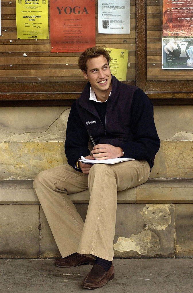Prince William is drawing on a pad of paper
