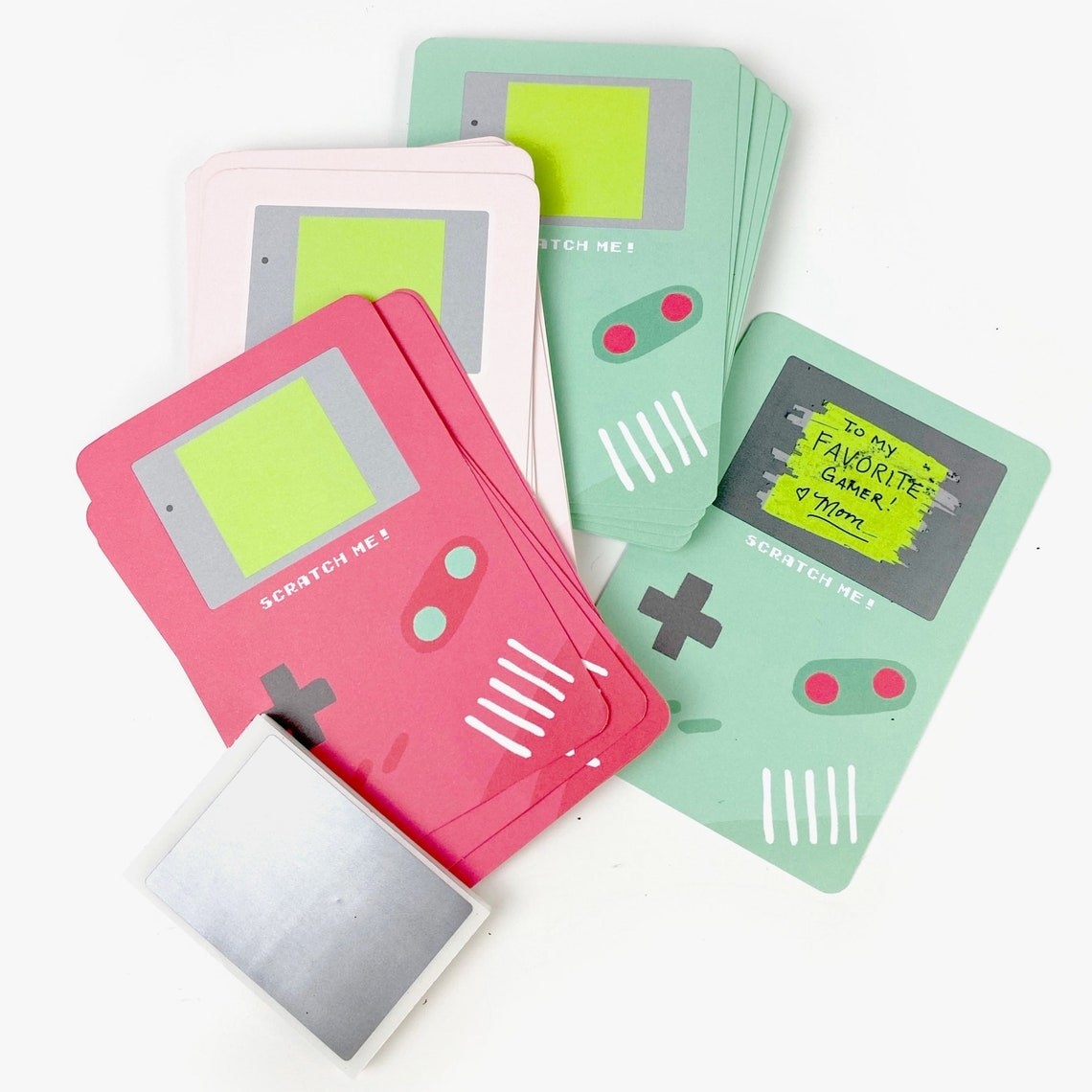 a bunch of scratch-off cards that look like gameboy systems