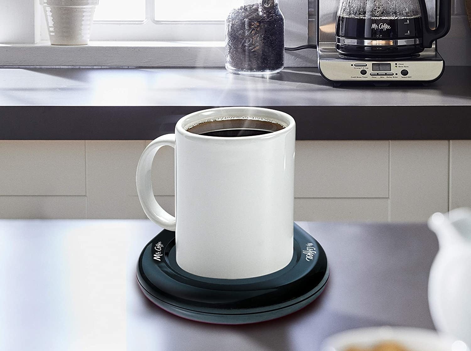 A mug filled with coffee placed on the warmer