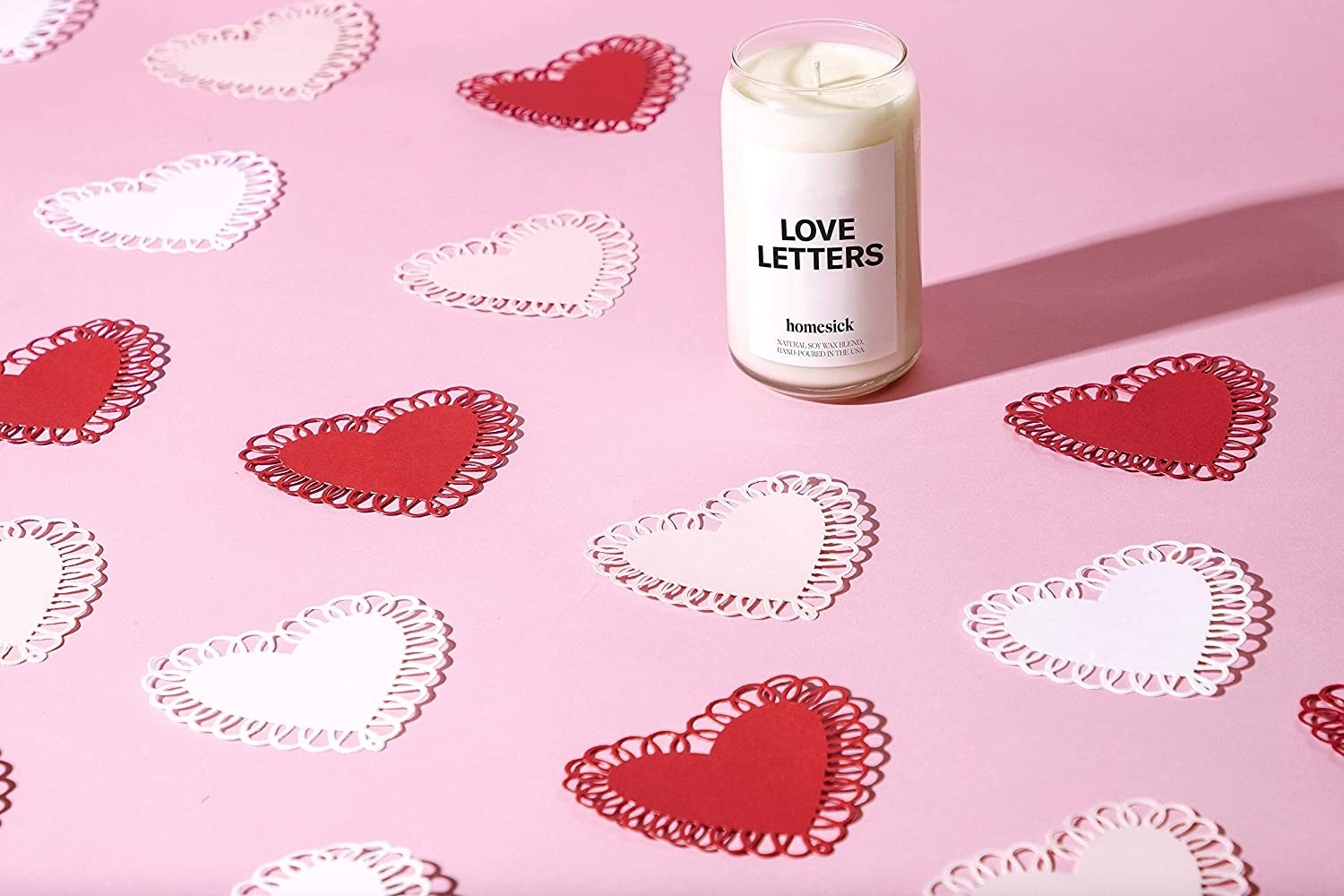 &quot;love letters&#x27; candle surrounded by paper hearts