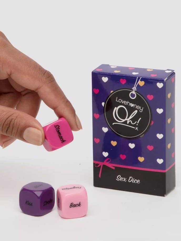 A model holding dice from a foreplay dice game