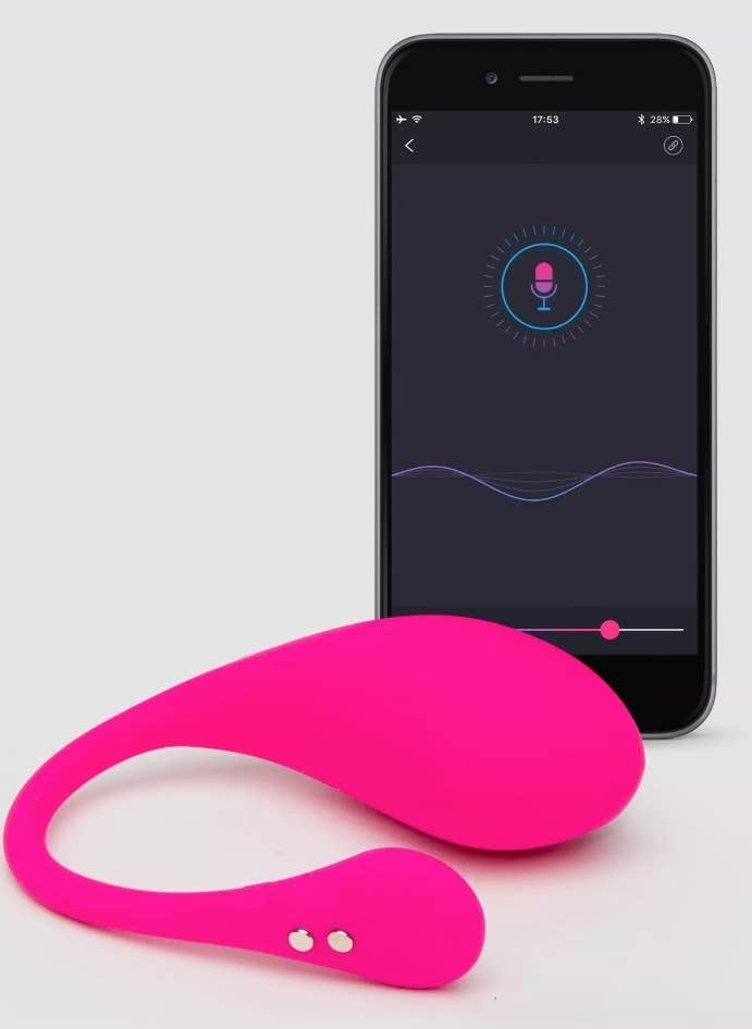 A pink egg vibrator aside a phone with a associated control app