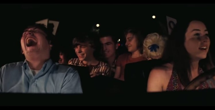 Alana driving a car with Gary, and co. while many of them laugh in &quot;Licorice Pizza&quot;