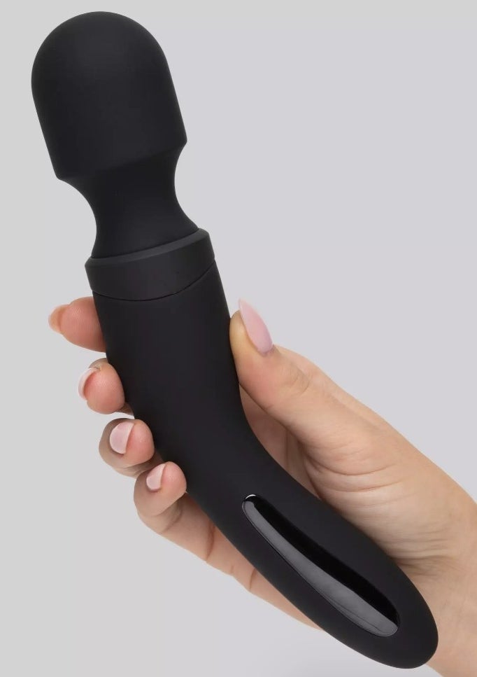 A model holding a black wand vibrator
