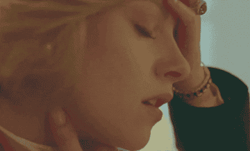 Kirsten as Princess Diana with her hand on her head needing a moment to herself