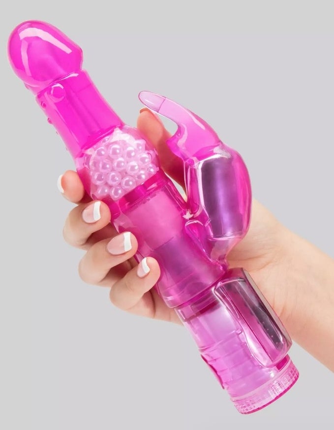 A model holding a pink rabbit vibrator
