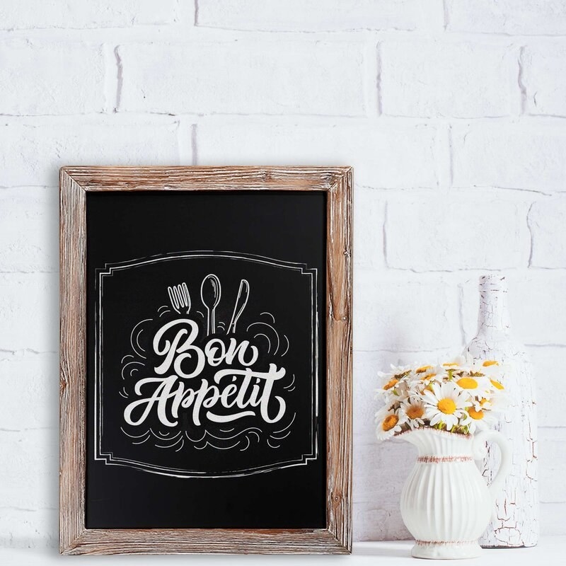 The chalkboard in a kitchen with the artsy design of &quot;bon appetit&quot;