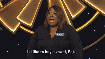 Loni Love competing on Wheel of Fortune and saying &quot;I&#x27;d like to buy a vowel, Pat&quot;