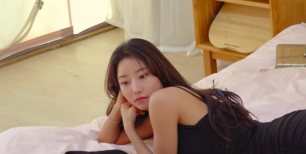 Yea-won looks distracted, lounging alone in bed