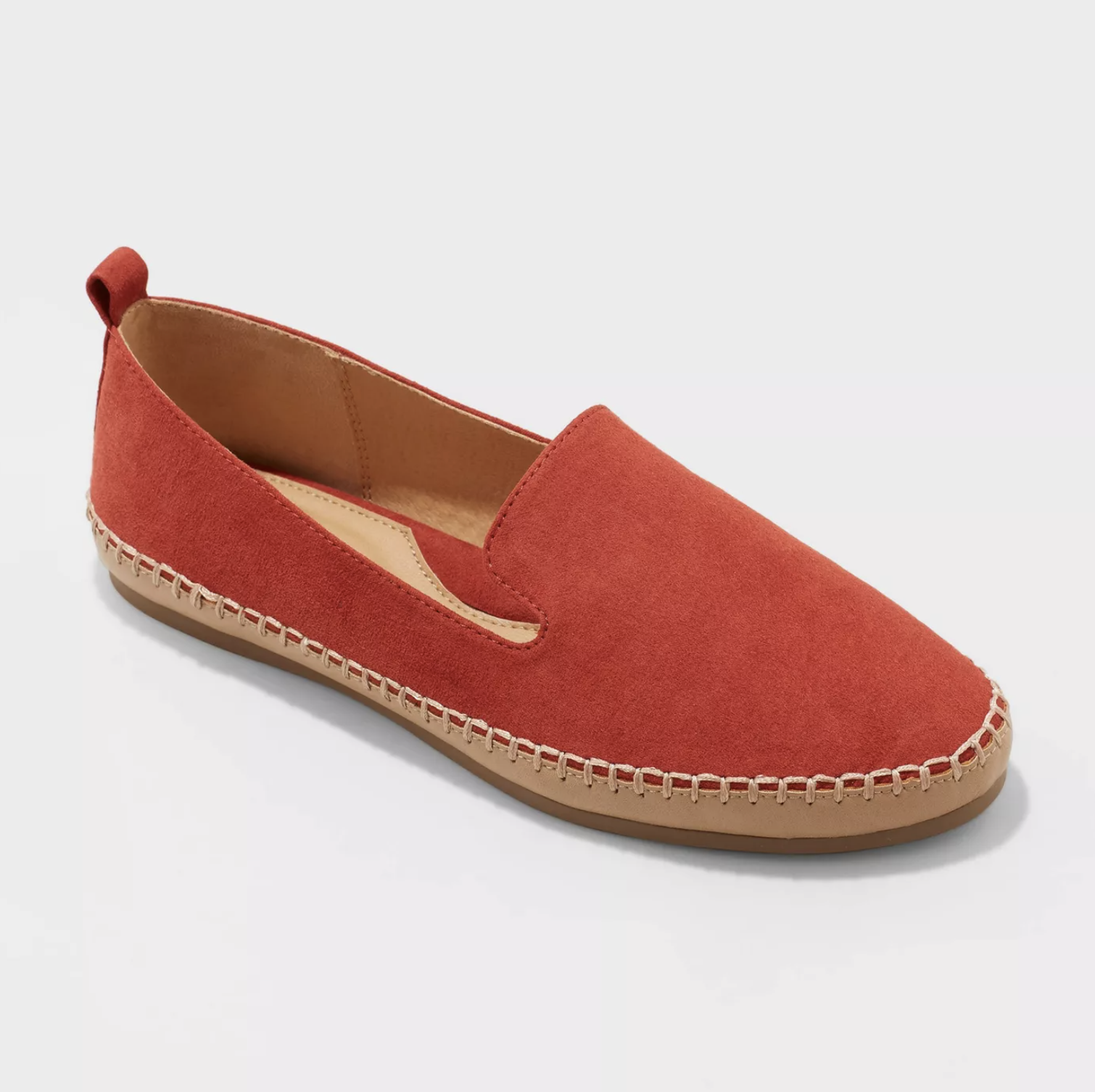 The red slip on flats have white stitching along the edges toward the sole