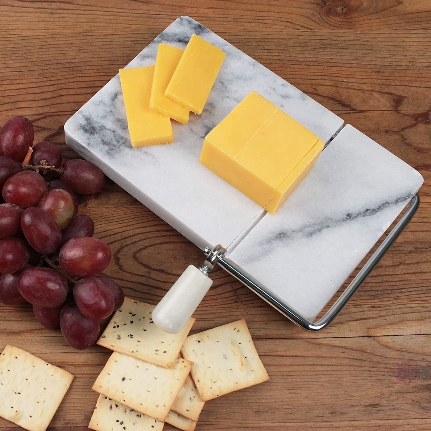 the marble cheese cutter with a sliced block of cheese sitting on top