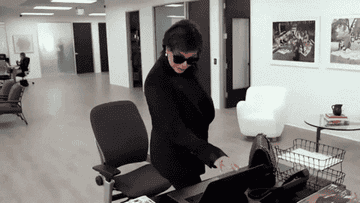 Kris Jenner closing a laptop