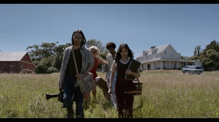 The main characters of &quot;X&quot; walking with their equipment through a field