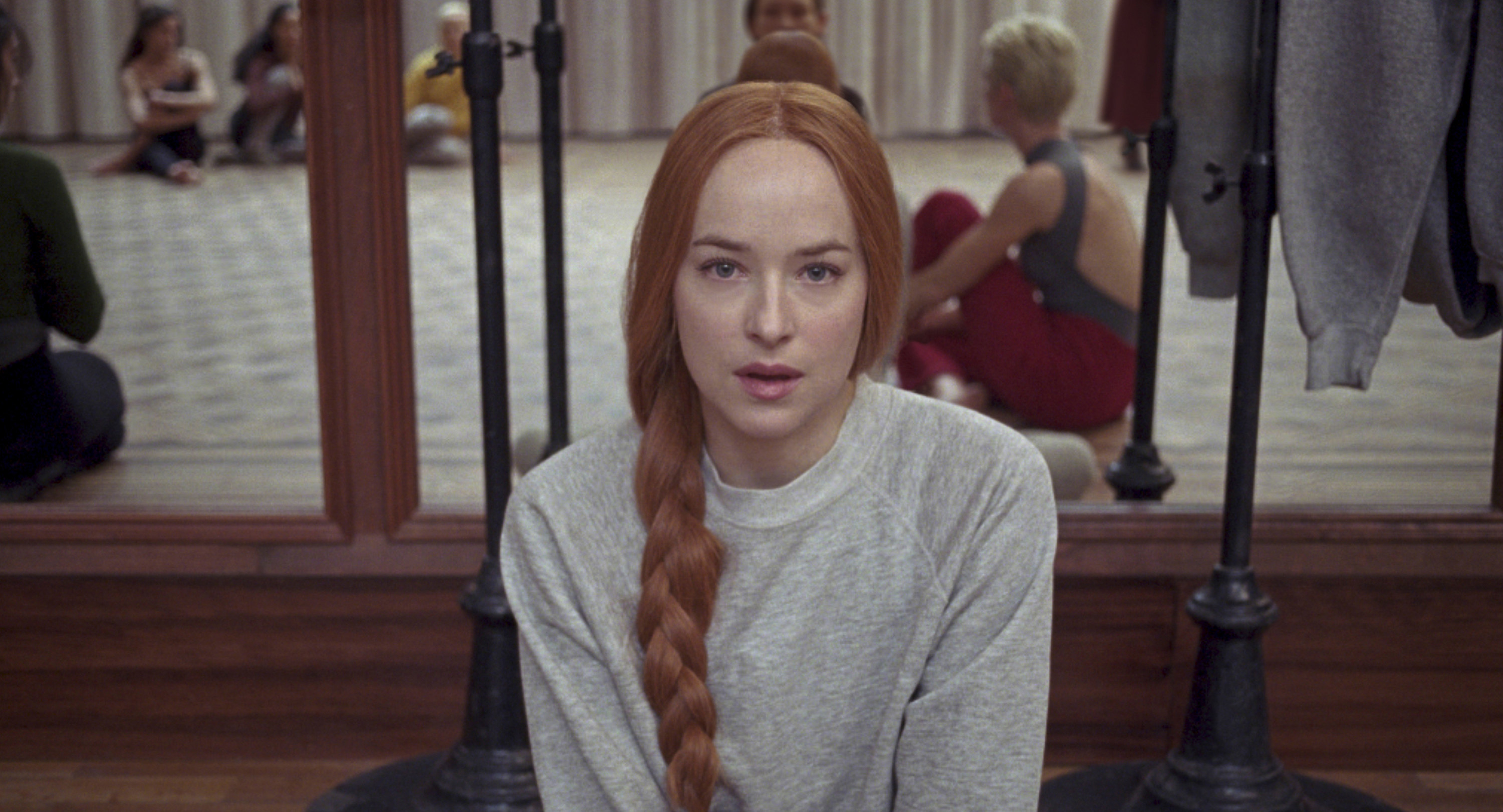 Johnson, who has naturally brunette hair, looks at the camera while wearing a long braid and rocking red hair