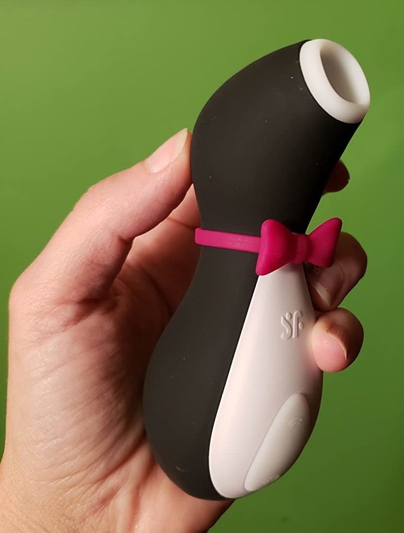 the black and white suction toy with a purple bow tie