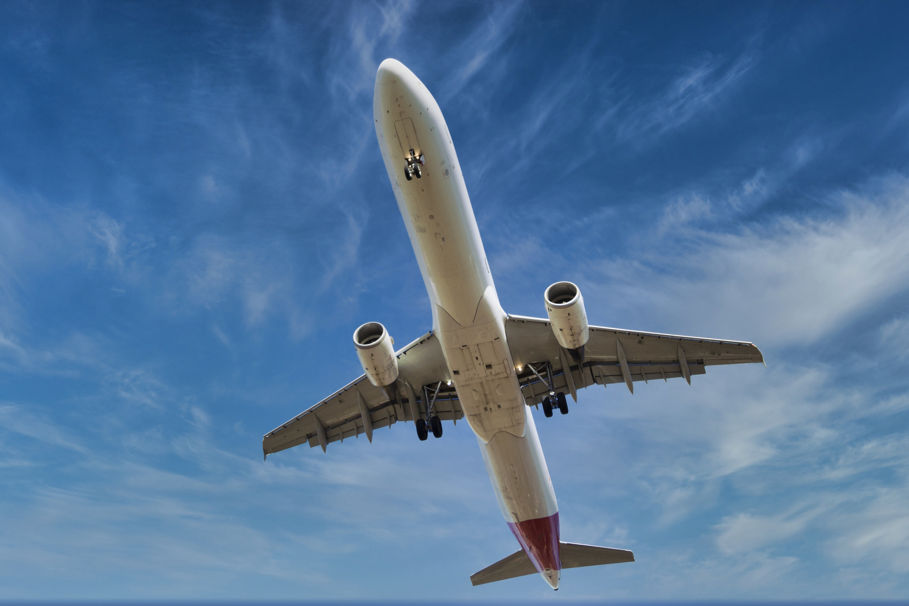 A view of the bottom of a plane flying into the sky