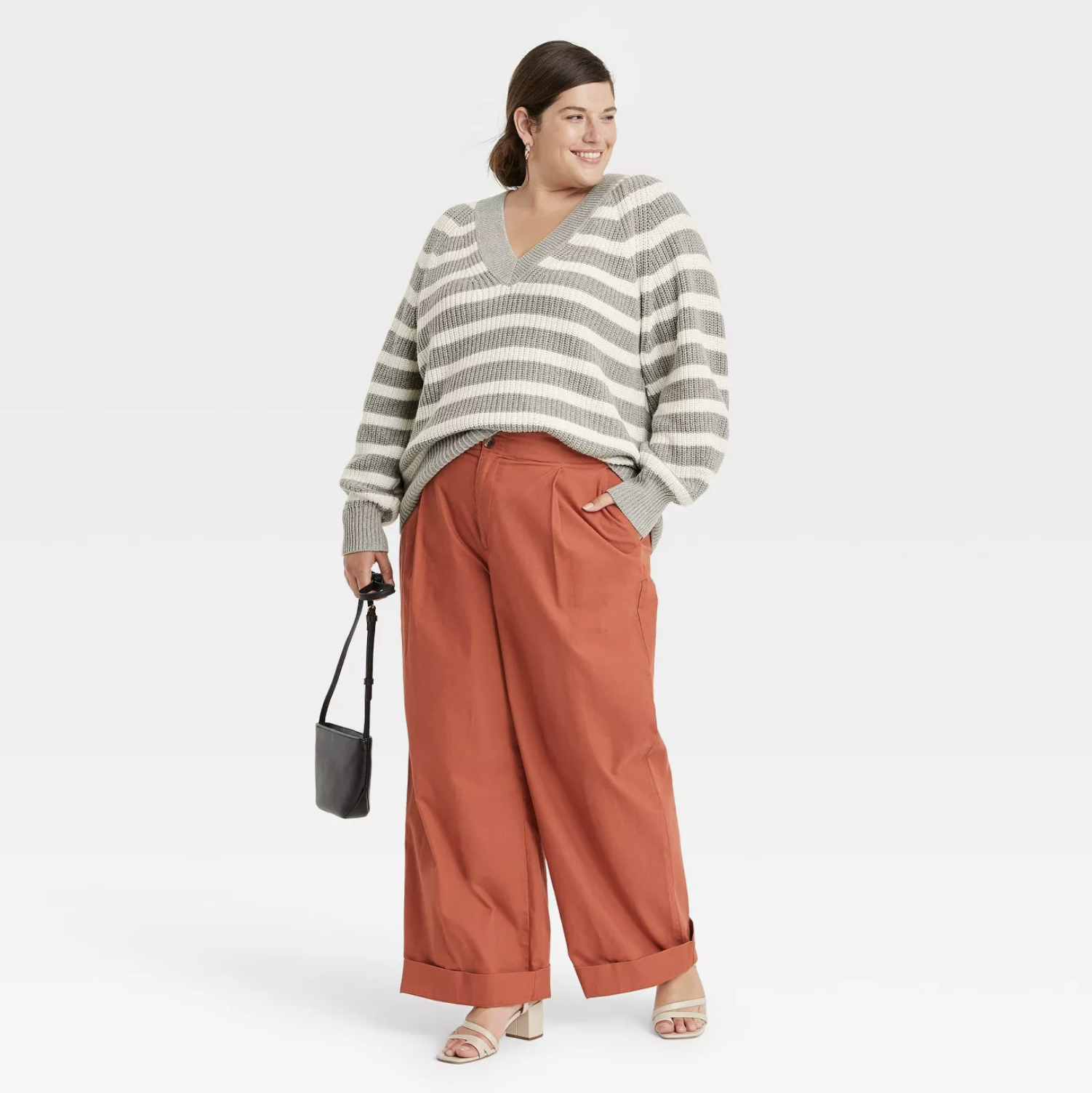model wearing striped pullover with orange pants