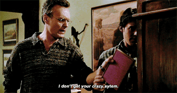 Giles sorting books and Xander saying